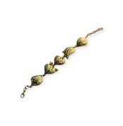 Gold-tone bracelet with leaf-shaped pod links on white background