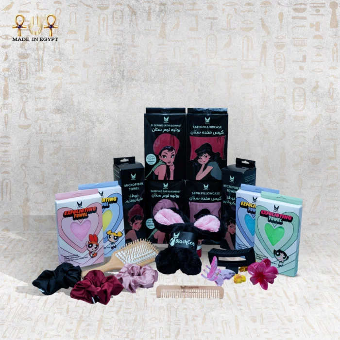 A complete display of Black Cat haircare and beauty essentials including satin bonnets, satin pillowcases, microfiber towels, exfoliating towels, hair accessories, and combs.