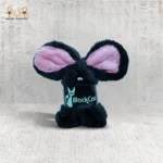 Black Bunny Clasp with pink inner ears standing upright on a patterned surface