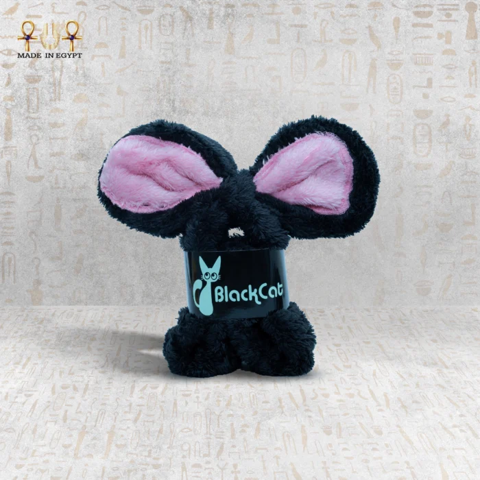 Black Bunny Clasp with pink inner ears standing upright on a patterned surface