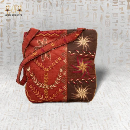 Front view of the City Pearl handwoven bag with floral and geometric embroidery in red and brown tones.