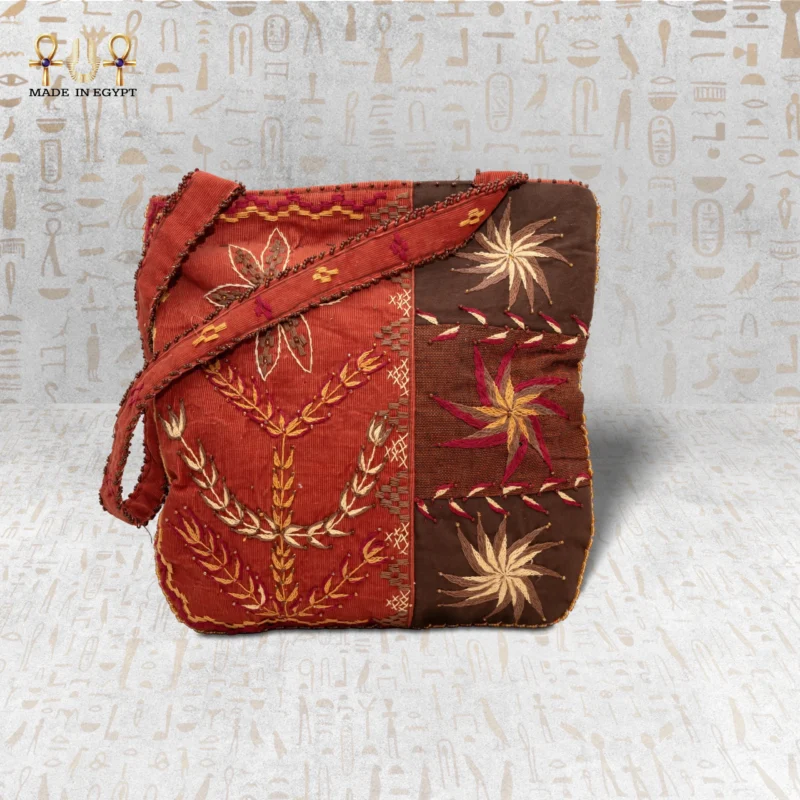 Front view of the City Pearl handwoven bag with floral and geometric embroidery in red and brown tones.