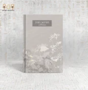 Minimalist autumn daily agenda notebook with delicate floral design on a soft grey cover, ideal for daily planning and journaling.