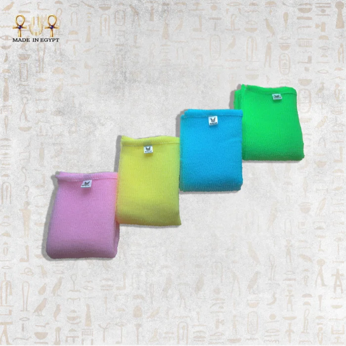 Close-up of four colorful Deep Exfoliating Towels in pink, yellow, blue, and green.