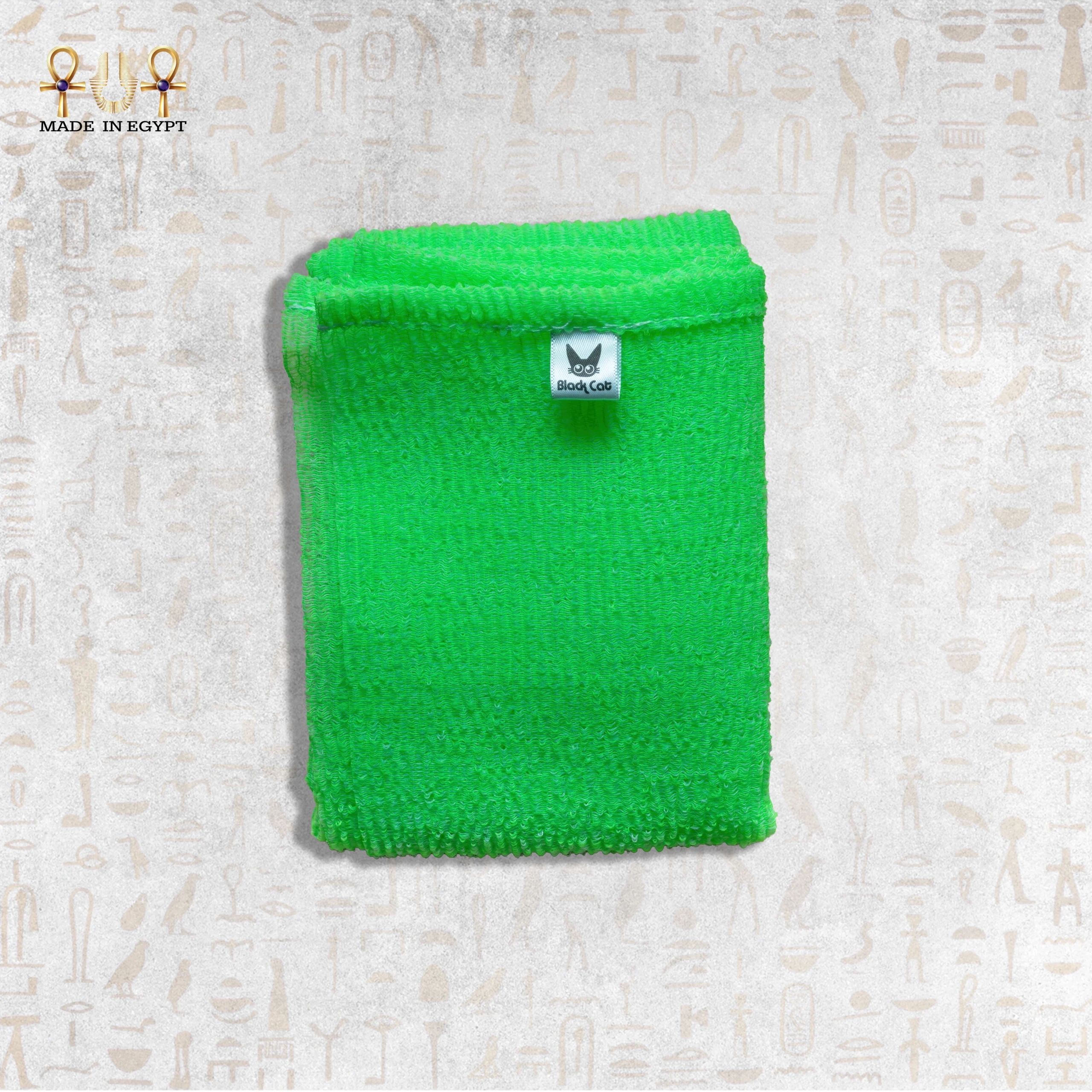 Close-up of Green Deep Exfoliating Towel by Black Cat Close-up of Green Deep Exfoliating Towel by Black Cat showing its texture and brand label.