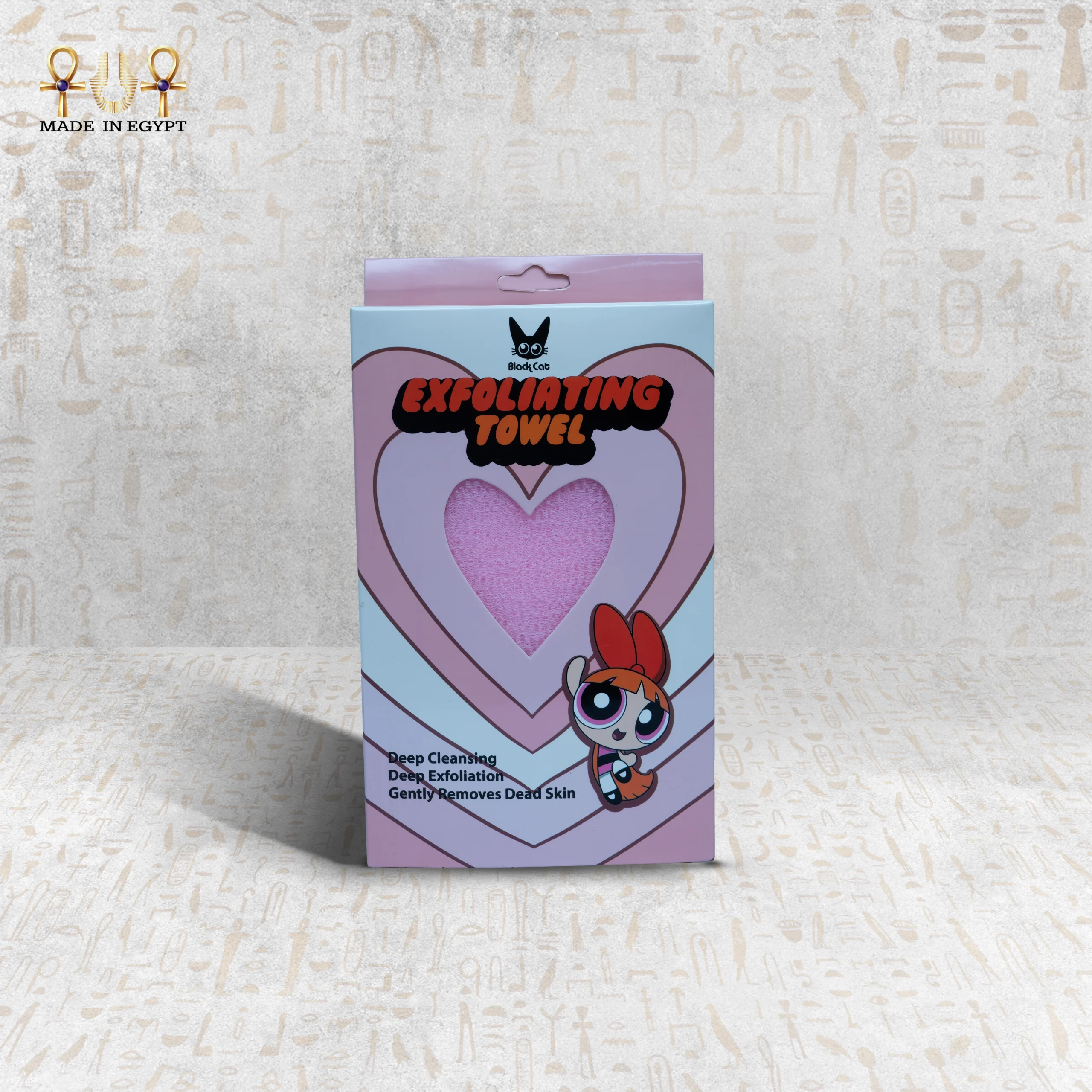 Pink Deep Exfoliating Towel in packaging by Black Cat Pink Deep Exfoliating Towel in packaging by Black Cat, featuring a heart-shaped cutout showcasing the towel.