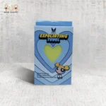 Yellow Deep Exfoliating Towel in packaging by Black Cat with a heart-shaped cutout showing the towel inside.