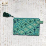 Handcrafted embroidered pouch featuring vibrant teal and blue flower designs with beaded detailing.