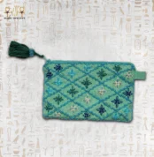 Handcrafted embroidered pouch featuring vibrant teal and blue flower designs with beaded detailing.