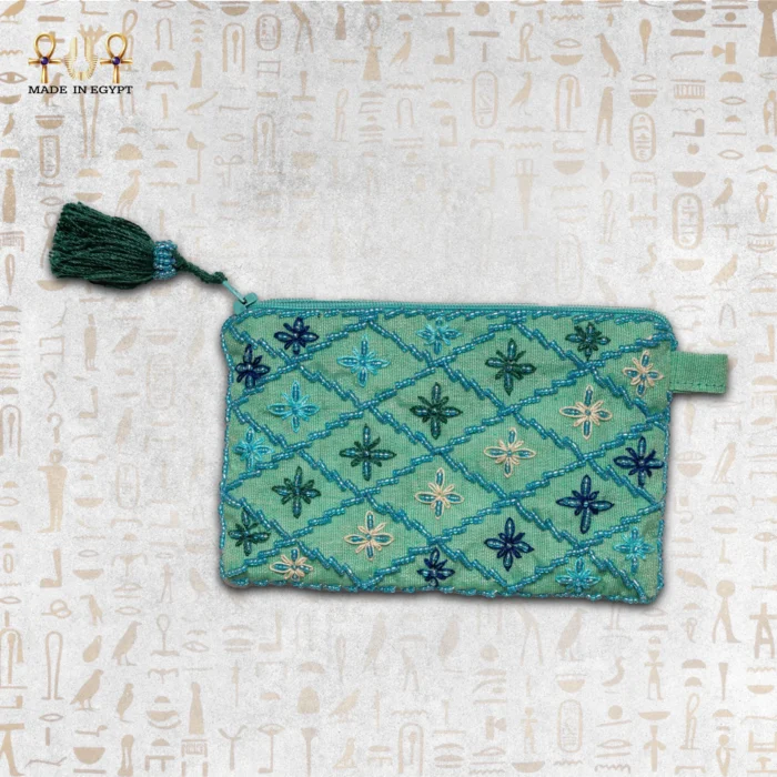 Handcrafted embroidered pouch featuring vibrant teal and blue flower designs with beaded detailing.