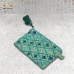 Handcrafted embroidered pouch from a slight angle, showcasing the overall design with vibrant floral patterns and beadwork.