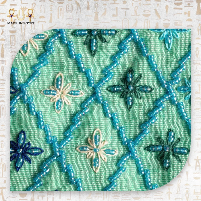 Close-up of the embroidered floral design on the "Emerald Gleam" pouch, focusing on the intricate beadwork.