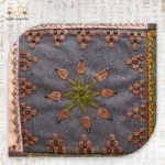 Flower embroidery with shades of green and brown on the Flower Squares bag, showing intricate stitching and beadwork.