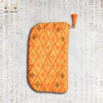 Orange embroidered pouch with tassel and beadwork, showcasing intricate diamond patterns with floral motifs.