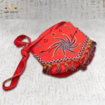 Side view of the Joyful Jasmine hand-embroidered bag showcasing the tassels and spiral design.