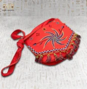 Side view of the Joyful Jasmine hand-embroidered bag showcasing the tassels and spiral design.
