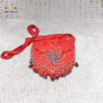Front view of the Joyful Jasmine hand-embroidered bag with a colorful spiral design and decorative tassels.