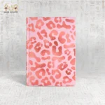 Pink leopard print notebook with metallic details and bold pattern, made in Egypt