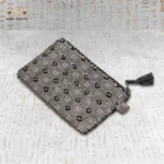 Side angle view of the Luxury Surprise clutch, emphasizing its sleek design and tassel zipper.