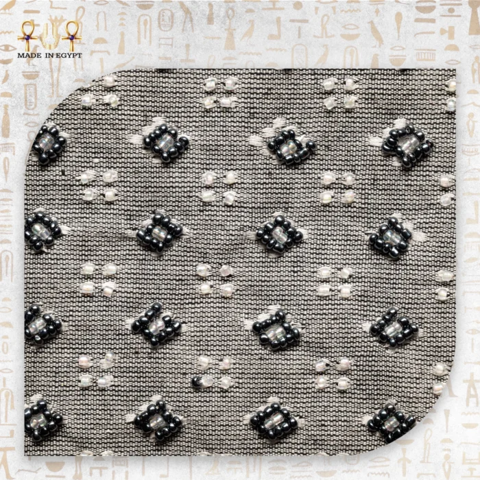 Close-up of the Luxury Surprise clutch's beaded floral pattern, showing black and white beads meticulously arranged.