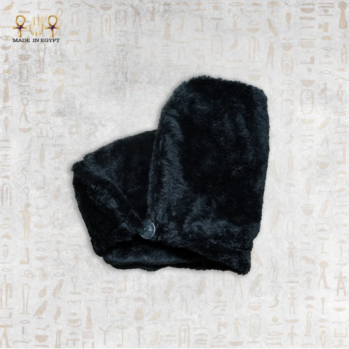 Soft, black microfiber towel folded with a button fastening.
