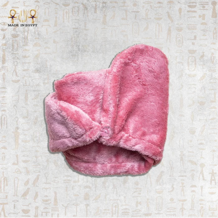 Soft and plush pink microfiber towel folded neatly with a button fastening.