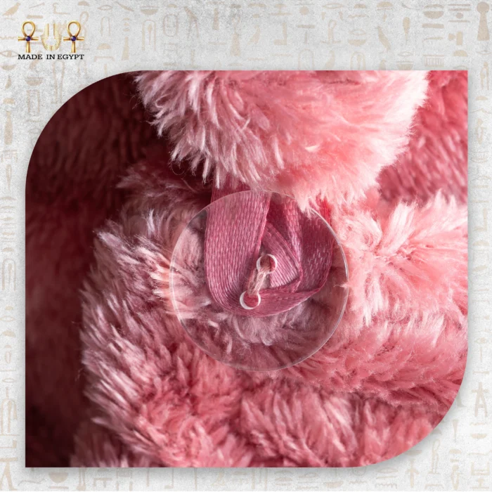 Close-up of the pink microfiber towel's fastening loop showing soft texture and fine stitching.