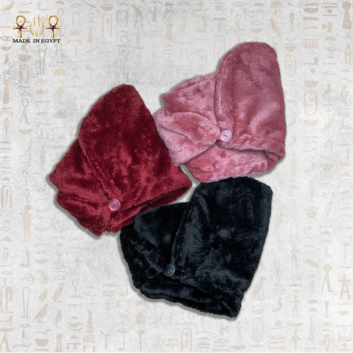 Three microfiber towels in red, pink, and black, each with button fastening.