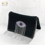 Side view of the Mysterious Gaze bag featuring a beaded eye motif with silver fringe on a black velvet clutch.