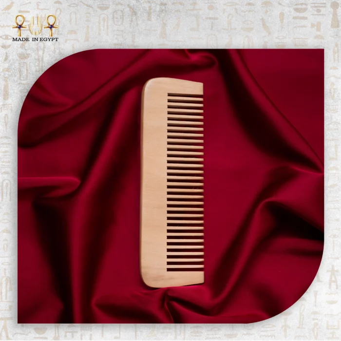 Natural Wooden Comb placed on red satin fabric.