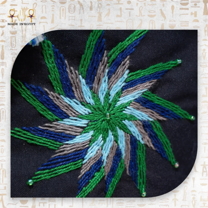 Close-up of the embroidered floral pattern on the Night Delight bag, showcasing vivid blues, greens, and reds with intricate stitching.