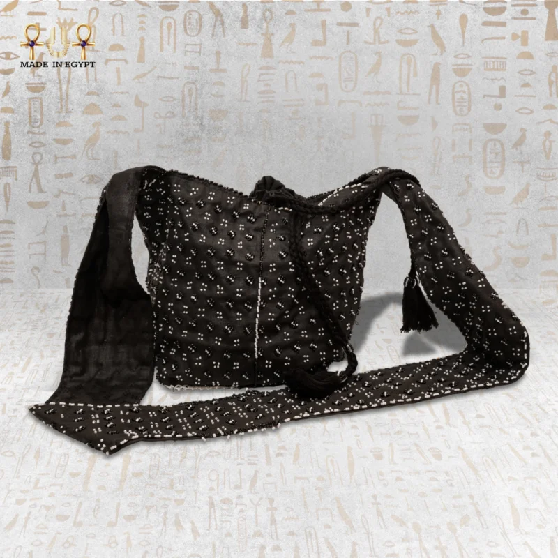 Full view of the "Night Mirror" handbag with intricate black and white beadwork, showing its long strap.
