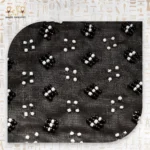 Close-up of the black and white bead patterns on the "Night Mirror" handbag fabric, highlighting the detailing.