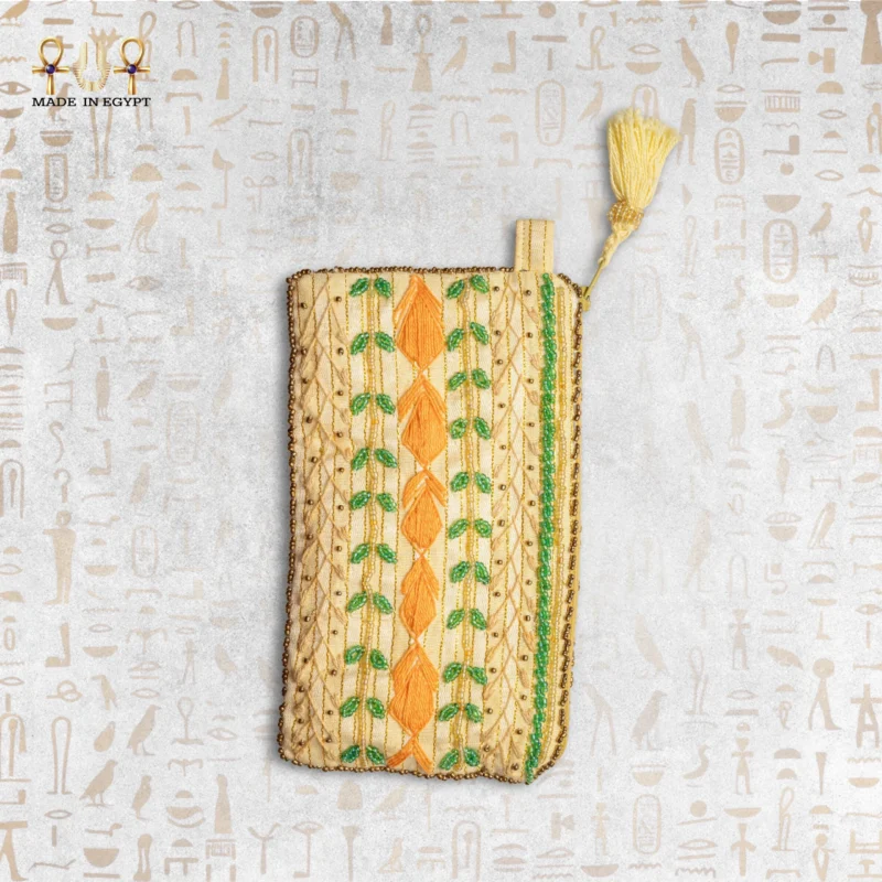 Nile Joy embroidered pouch with vibrant orange and green thread details.