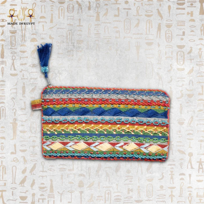 Nubian Delight pouch with intricate multi-colored embroidery, featuring red, blue, yellow, and green beads with a blue tassel.
