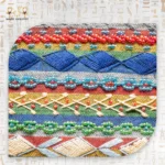 Close-up of Nubian Delight pouch’s embroidered patterns in red, yellow, green, and blue beads with woven threads.