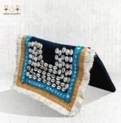 Side view of the Nubian Pearl bag with natural shells, turquoise embroidery, golden borders, and white fringes.