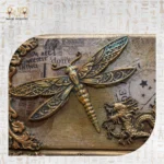 Close-up of dragonfly and dragon embellishments on the Royal Drawers Unit’s upper section.