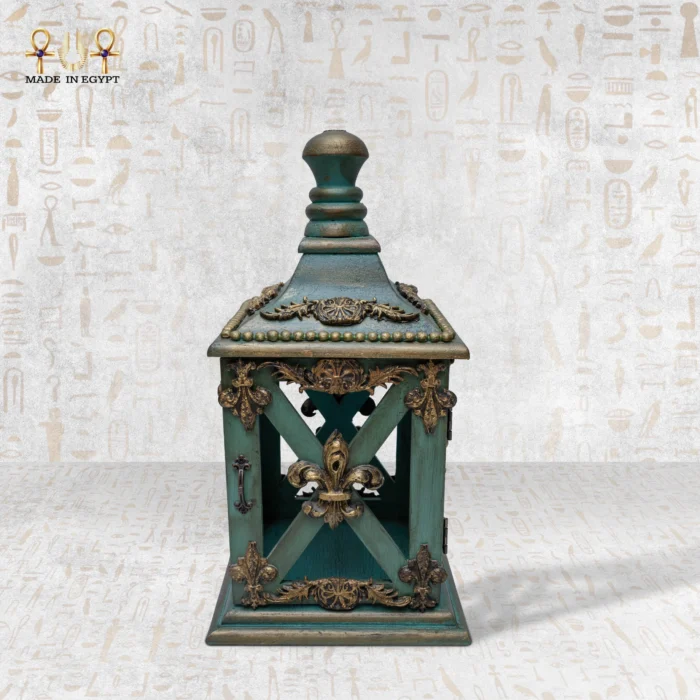 Small handcrafted wooden lantern with antique green finish and golden details.