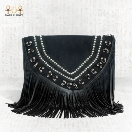 Close front view of the Royal Shadow bag displaying its silver decorative patterns and bold black fringes.