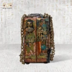 Close-up of side engravings on Secret of the Pharaonic Scarab bag with Bastet and hieroglyphs.