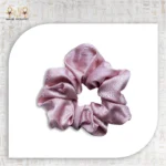 Shiny Tie pink satin scrunchie isolated on white background.