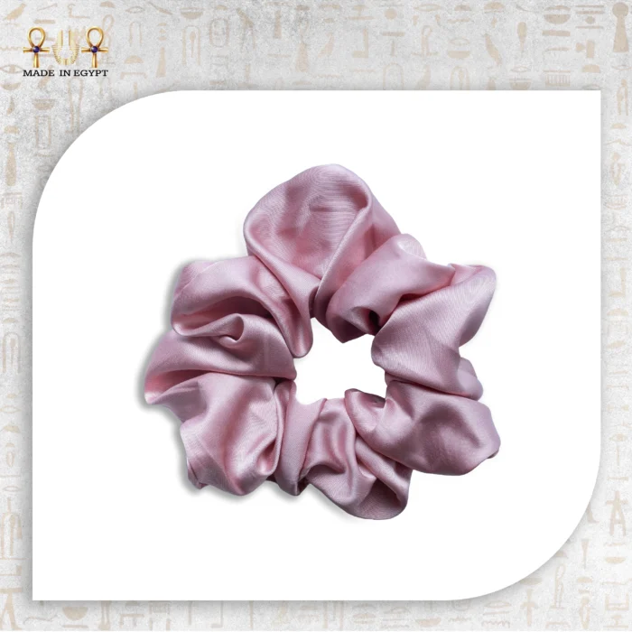 Shiny Tie pink satin scrunchie isolated on white background.