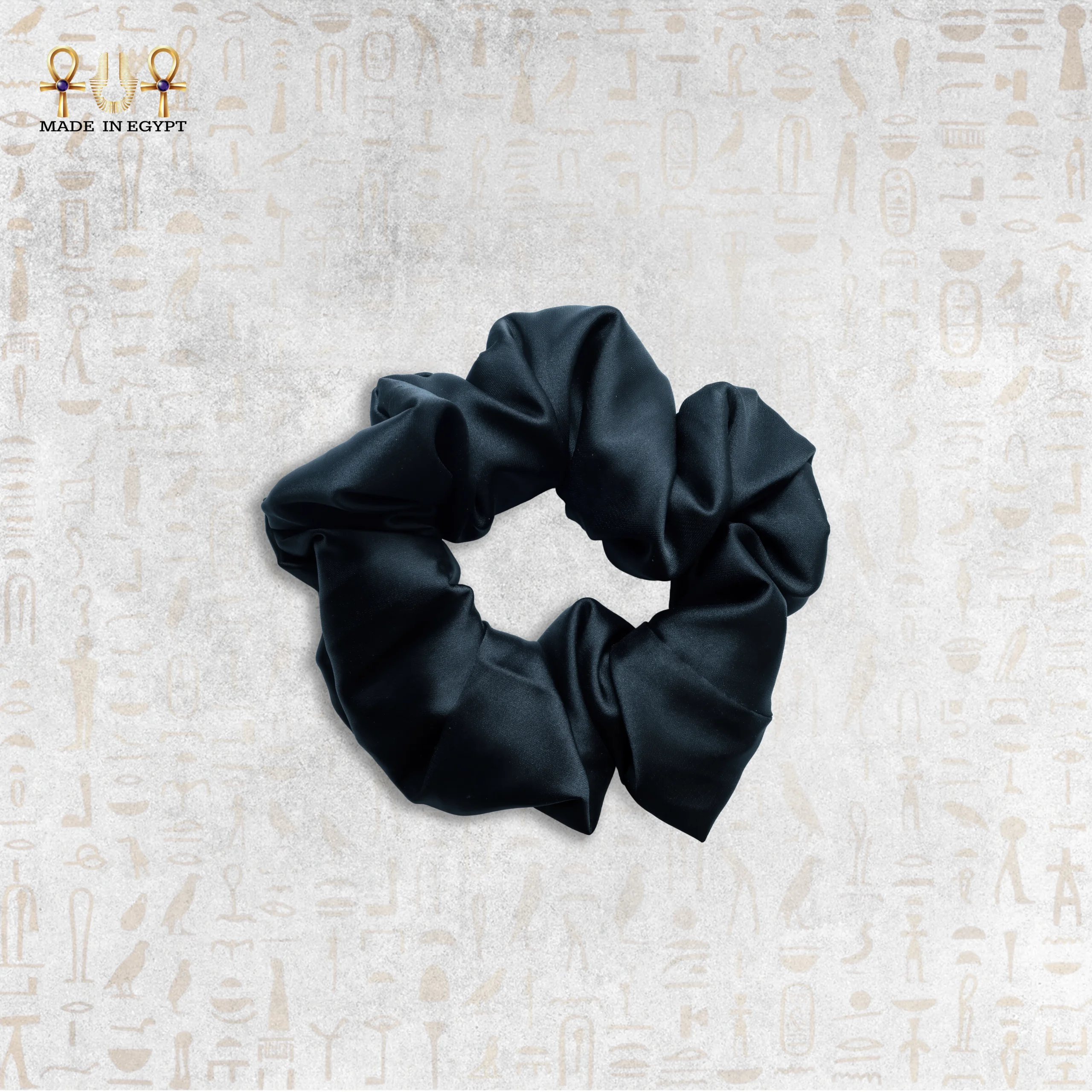 Black Silk Hair Tie - Elegant and Durable Hair Accessory Close-up of a luxurious black silk hair tie on a white background.