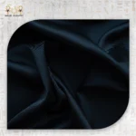 Black satin pillowcase fabric close-up with smooth and luxurious texture.