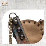 Close-up of Soul Sun bag showing intricate ankh and wing detailing in vivid turquoise and gold.