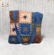 Star Ornament handcrafted handbag made from durable fabric, featuring vibrant star embroidery and modern design with spacious interior.