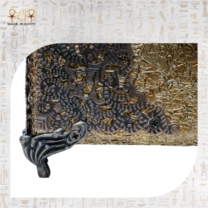 Close-up of ornate metal corner and sculpted foot of the Sultana bag, highlighting its antique craftsmanship.