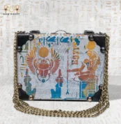 The Secret of Eternity bag front view with winged scarab and ancient Egyptian sun symbol