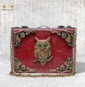 Handcrafted wooden “The Zodiac Sage” bag with ornate owl motif and green gemstone accents.